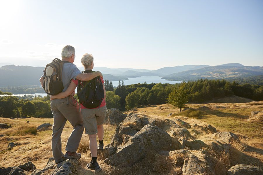 Employee Benefits - Mature Couple on a Hike Admiring the Landscape Views